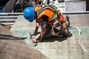 A roofing contractor inspecting a low-quality roof