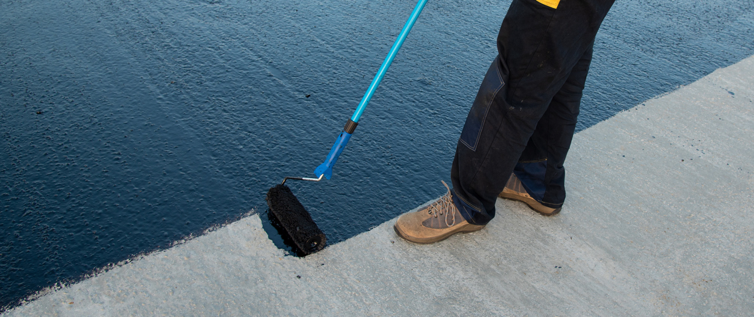 Worker Applies Bitumen Mastic On The Foundation