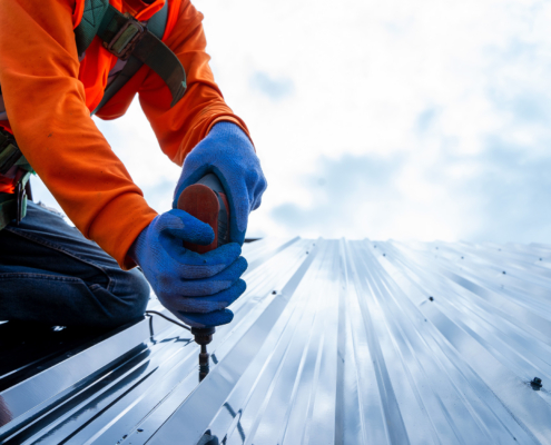 Worker In Metal Commercial Roof